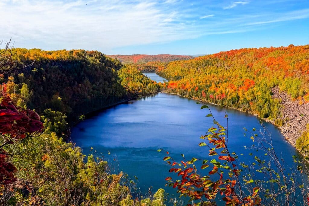 Lake framed by red, orange and gold fall color on Minnesota North Shore