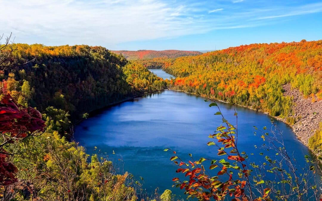 Lake framed by red, orange and gold fall color on Minnesota North Shore